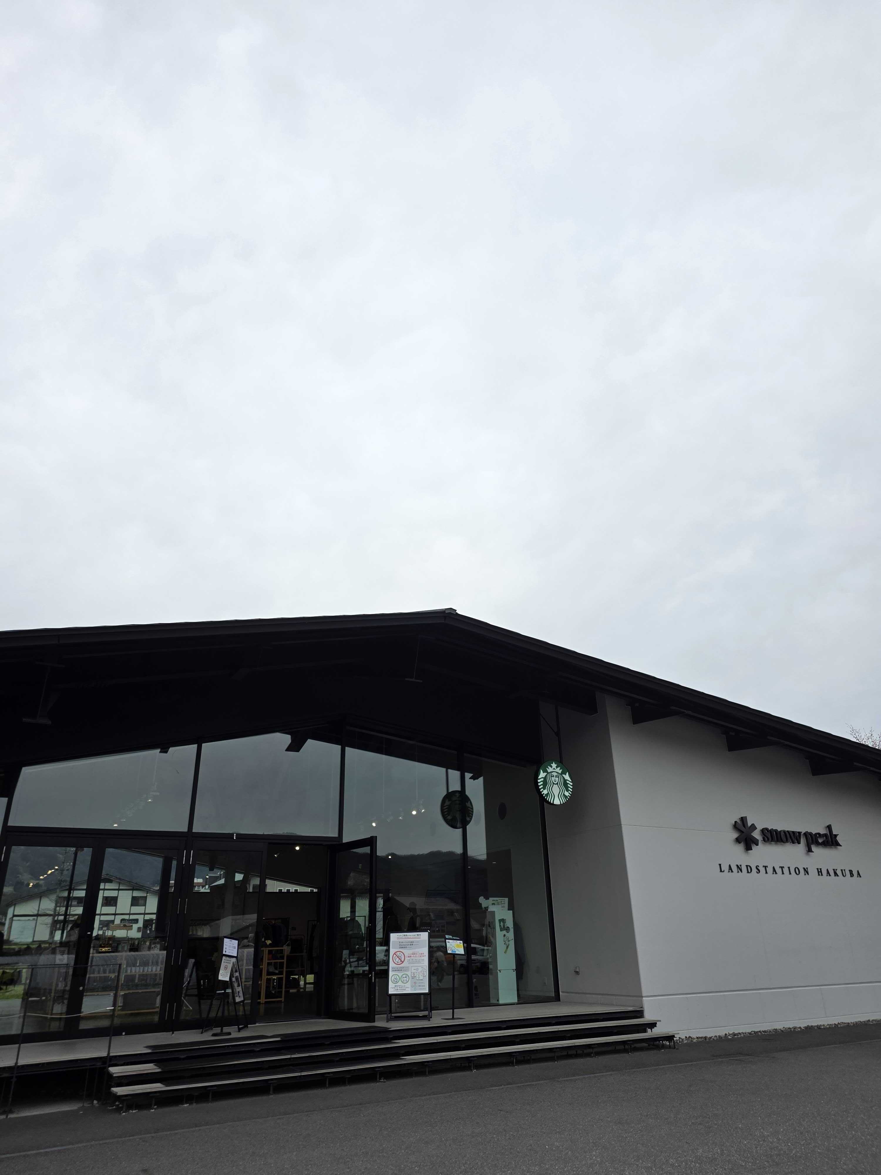 Snow Peak Land Station Hakuba entrance showing Starbucks and Snow Peak signage